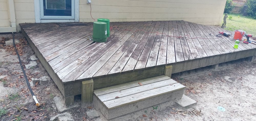 Old rotted backyard deck before replacement